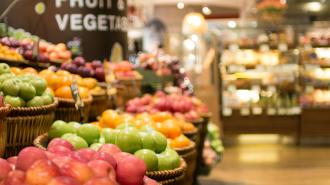 Buckets of apples at a grocery store.